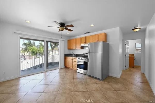 a kitchen with stainless steel appliances granite countertop a refrigerator and a stove top oven