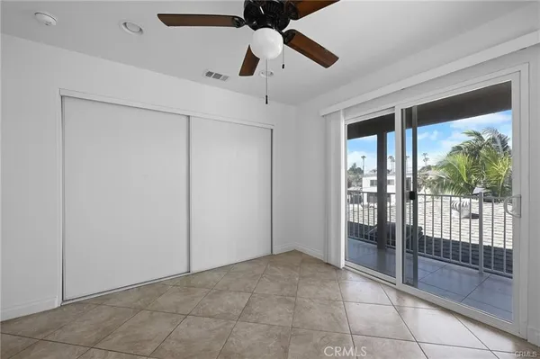 a view of an empty room and window ceiling fan