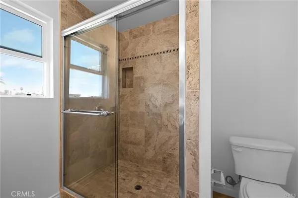 a bathroom with a shower and toilet
