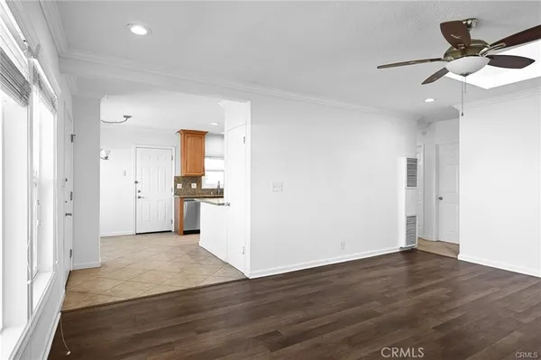 a view of a kitchen with wooden floor and a ceiling fan