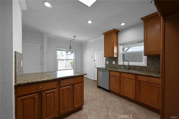 a kitchen with granite countertop sink cabinets and window