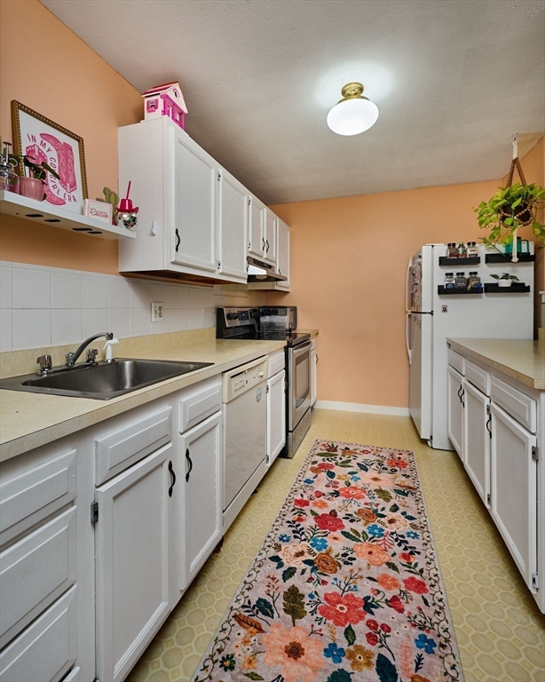 48 Evergreen Road, Unit 312 Leeds, MA 01053 - Photo 12 of 22 a kitchen with sink cabinets and stove