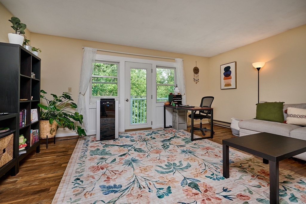 48 Evergreen Road, Unit 312 Leeds, MA 01053 - Photo 6 of 22 a living room with furniture a window and a flat screen tv