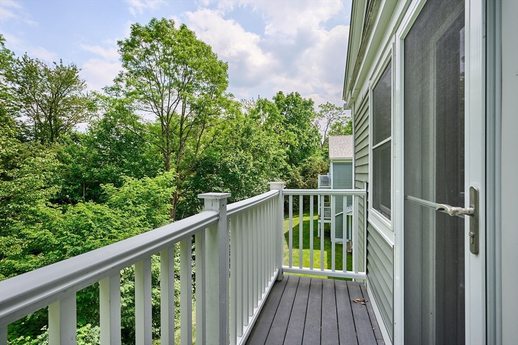 48 Evergreen Road, Unit 312 Leeds, MA 01053 - Photo 9 of 22 a balcony with trees in front of it
