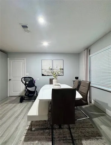 a dining room with furniture and window