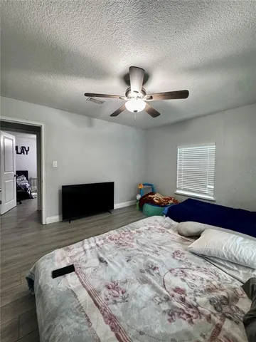 a bed room with a bed and a television