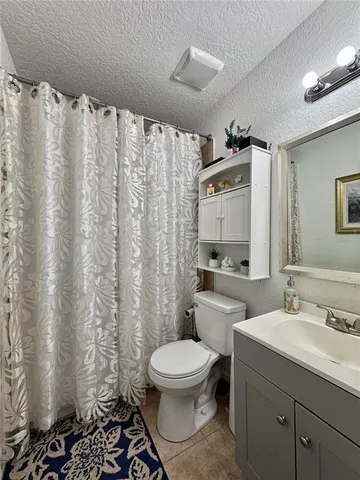 a bathroom with a toilet a sink and a mirror
