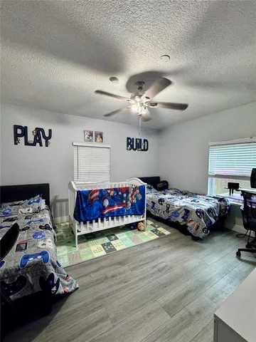 a bedroom with bed and a chandelier