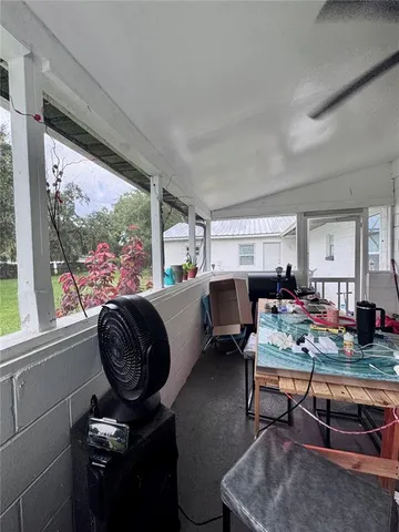 a living room with furniture and a floor to ceiling window