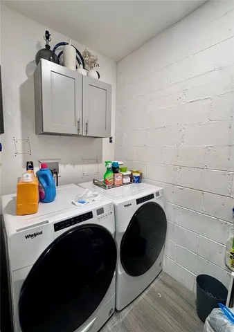 a utility room with sink dryer and washer