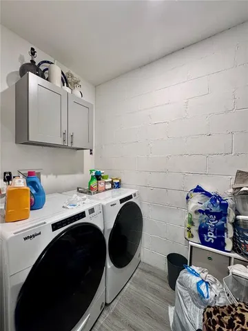 a utility room with sink dryer and washer