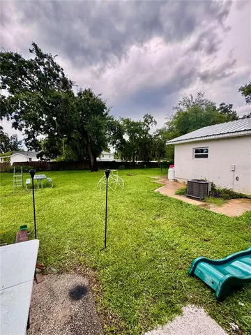 a view of a backyard with swimming pool