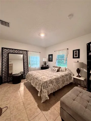 a bedroom with a bed and a large mirror