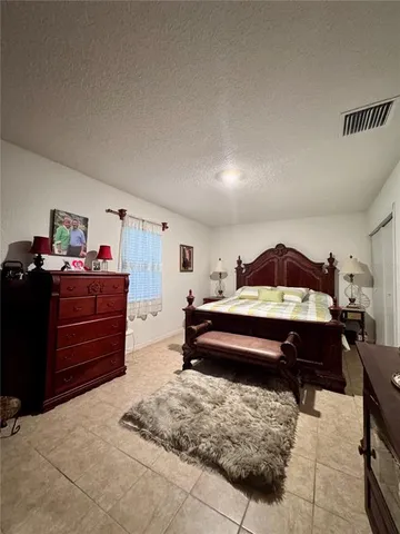 a bedroom with a bed and dresser