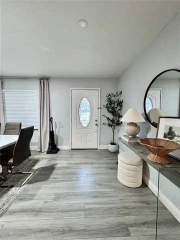 a living room with furniture a window and a clock