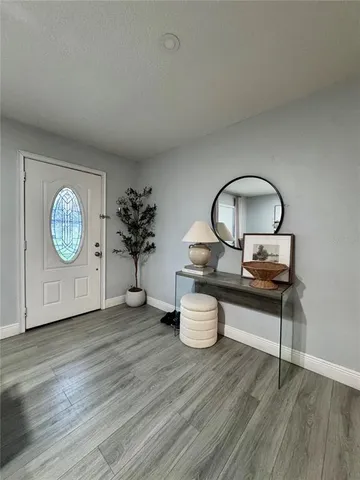 an empty room with wooden floor and glass door