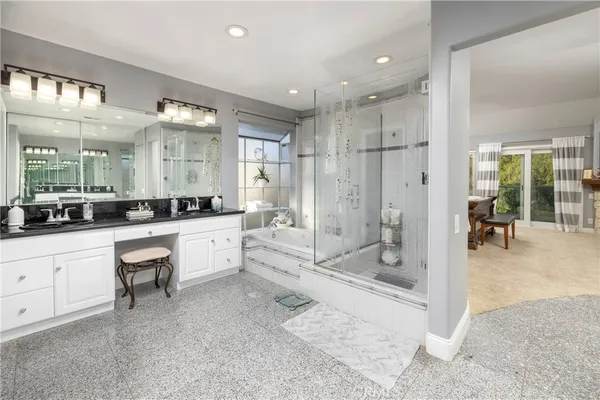 a large bathroom with a glass door shower a sink and a mirror