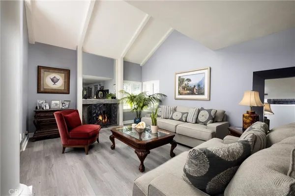 a living room with furniture a fireplace and a flat screen tv