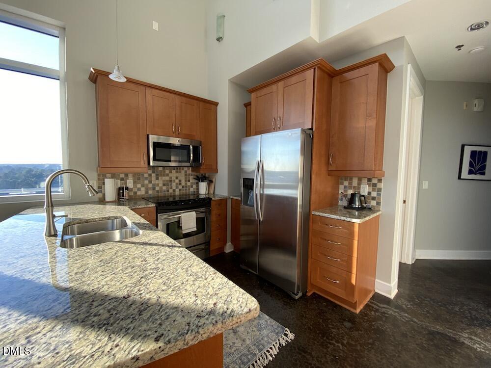 2608 Erwin Road, Unit 430 Durham, NC 27705 - Photo 14 of 43 a kitchen with granite countertop a refrigerator and a sink