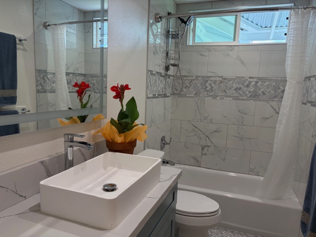 856 Ho'olala Place Hilo, HI 96720 - Photo 22 of 30 a bathroom with a toilet a sink and bathtub