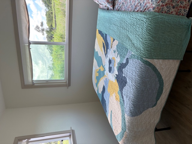 856 Ho'olala Place Hilo, HI 96720 - Photo 23 of 30 a bed sitting in a bedroom next to a window