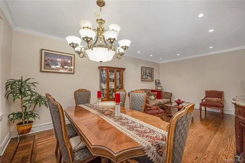a view of a dining room with furniture wooden floor and chandelier
