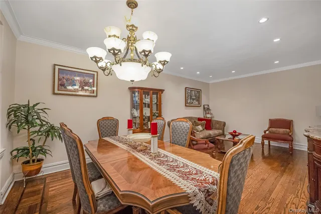 a view of a dining room with furniture wooden floor and chandelier
