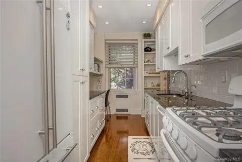 a kitchen with stainless steel appliances granite countertop a stove and a sink