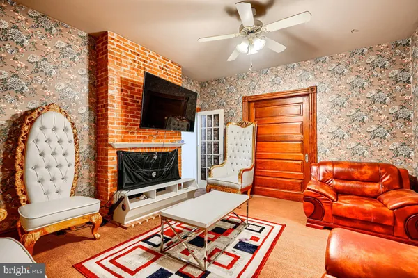 a living room with furniture a flat screen tv and a fireplace