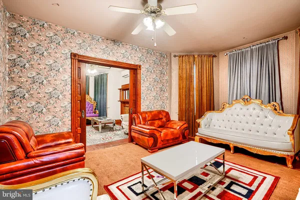 a living room with furniture and a chandelier
