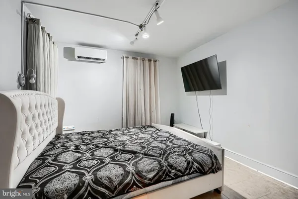a bedroom with a bed and a walk in closet