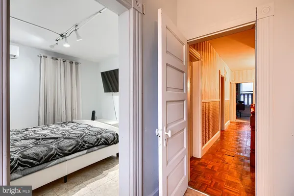 a bedroom with a bed and flat screen tv