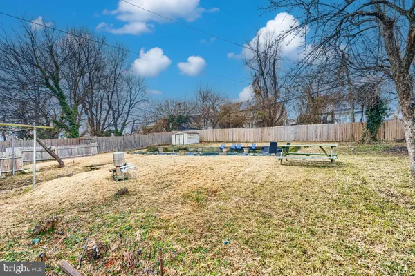 a view of a house with a yard and sitting area