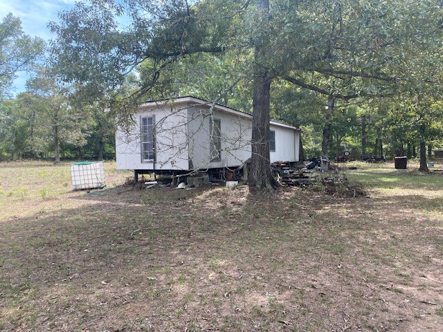 0 Firetower Road Conroe, TX 77306 - Photo 8 of 15 a backyard of a house with yard and outdoor seating