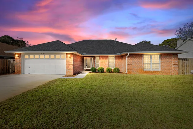 a front view of house with yard and trees