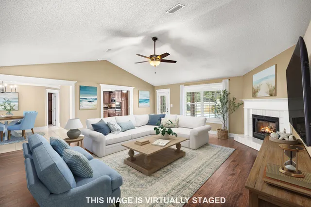 a living room with furniture fireplace and a table