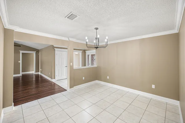 a kitchen with granite countertop wooden cabinets and a stove top oven