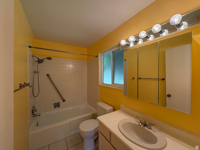 595 Meadowlark Road Orem, UT 84097 - Photo 31 of 87 Bathroom featuring a single vanity with an integrated sink, a large mirrored medicine cabinet, a vanity light fixture, and a bathtub with a tiled surround