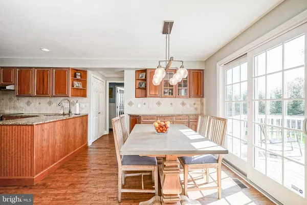 a dining room with a sink table and chairs