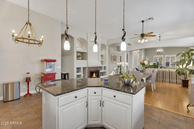 a spacious bedroom with a bed and a chandelier