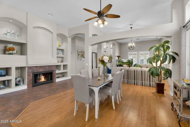 a bedroom with a bed flat screen tv and couches