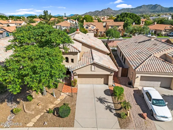 an aerial view of a house with a yard