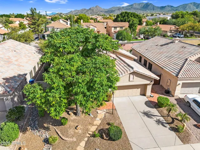 an aerial view of a house with garden space and street view