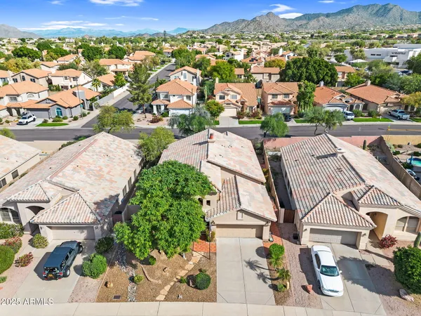 an aerial view of a house with a yard