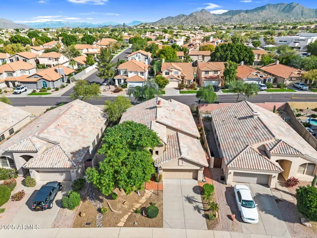 an aerial view of a house with a yard