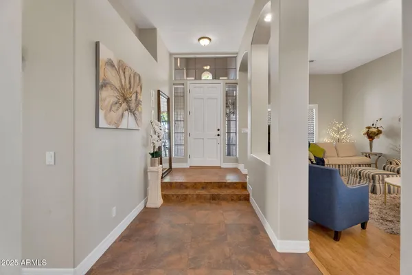a kitchen with stainless steel appliances kitchen island granite countertop a table chairs and a refrigerator