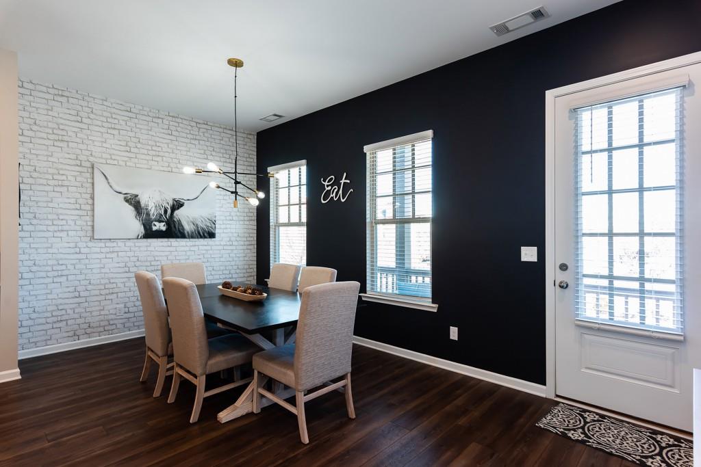 2575 Morehead Street Norcross, GA 30071 - Photo 19 of 36 a dining room with furniture a chandelier and wooden floor
