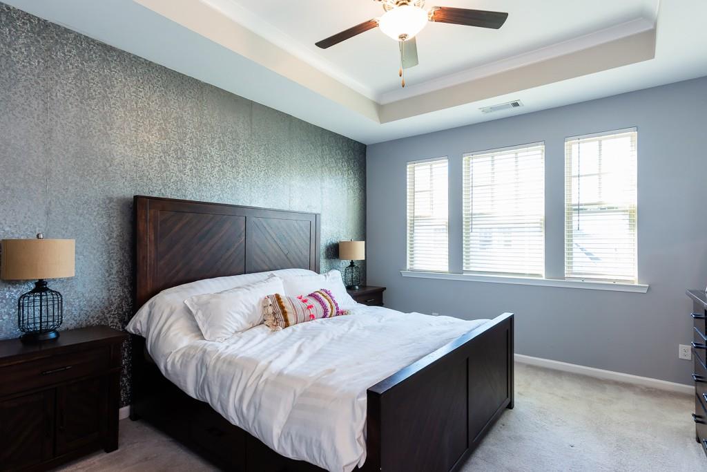 2575 Morehead Street Norcross, GA 30071 - Photo 4 of 36 a bedroom with a large bed and a lamp on dresser