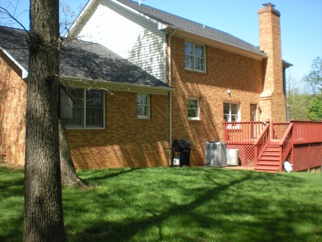 422 Stonehaven Lane Blue Ridge, VA 24064 - Photo 3 of 44 a view of backyard with a barbeque grill potted plants and large tree