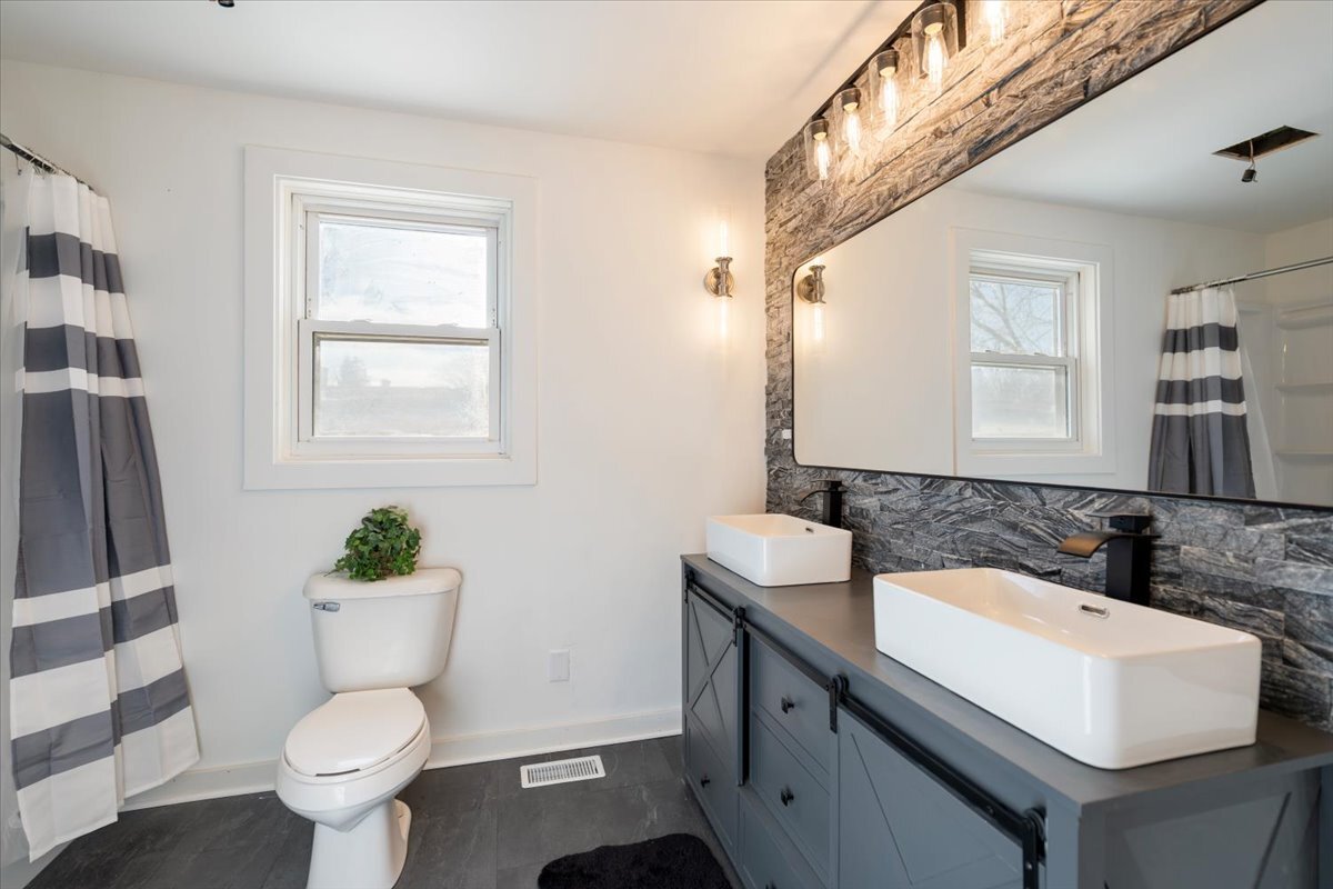 318 East Liberty Street Wauconda, IL 60084 - Photo 3 of 30 a bathroom with a sink toilet and a mirror
